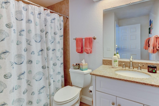 bathroom featuring a shower with curtain, vanity, and toilet