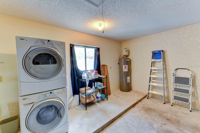 clothes washing area featuring a textured ceiling, electric water heater, and stacked washer / drying machine