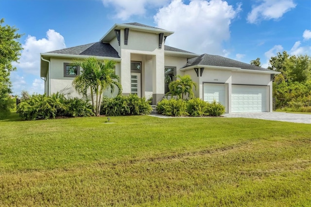 view of front facade with a garage and a front lawn