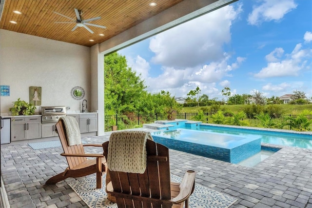 view of swimming pool featuring ceiling fan, sink, exterior kitchen, a patio area, and a grill