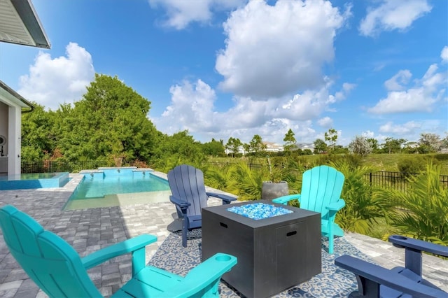 view of patio / terrace with a fenced in pool and an outdoor fire pit