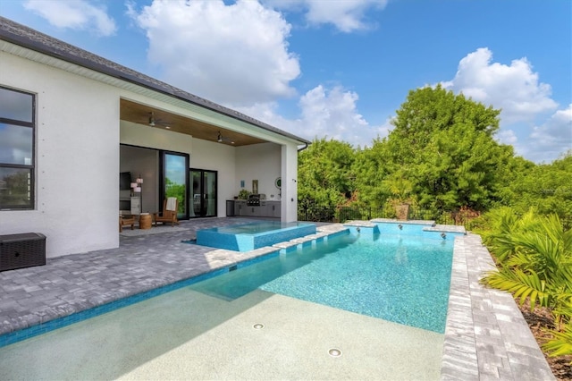 view of pool featuring an in ground hot tub, a patio, and ceiling fan