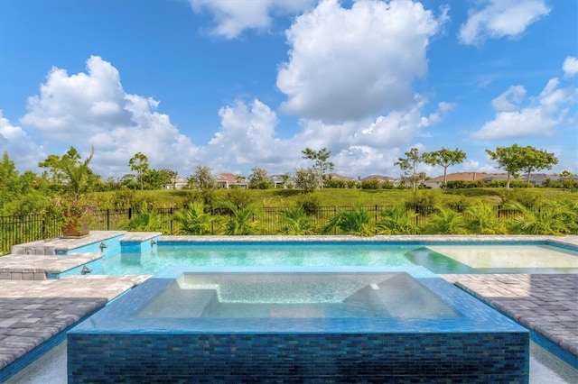 view of swimming pool with an in ground hot tub and a patio