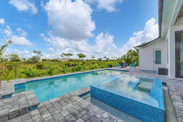 view of pool featuring a patio area and an in ground hot tub