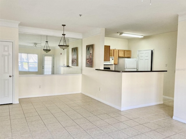 kitchen featuring kitchen peninsula, white appliances, crown molding, light tile patterned floors, and decorative light fixtures