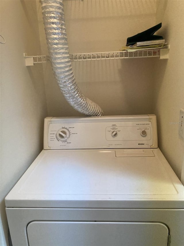 clothes washing area featuring washer / dryer