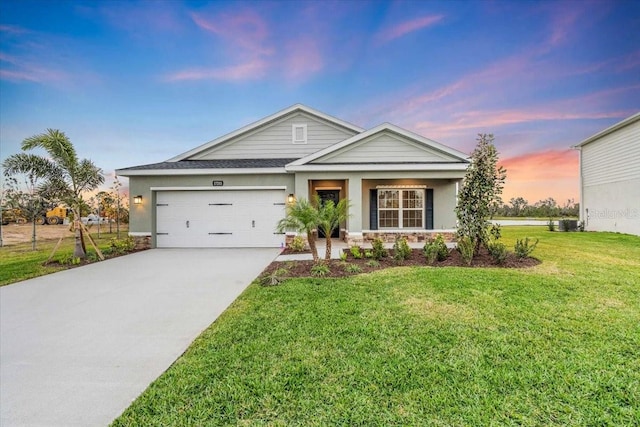 view of front of home with a yard and a garage