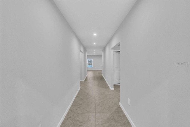 hall with light tile patterned floors