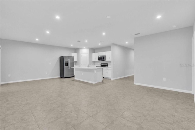 unfurnished living room featuring sink and light tile patterned floors