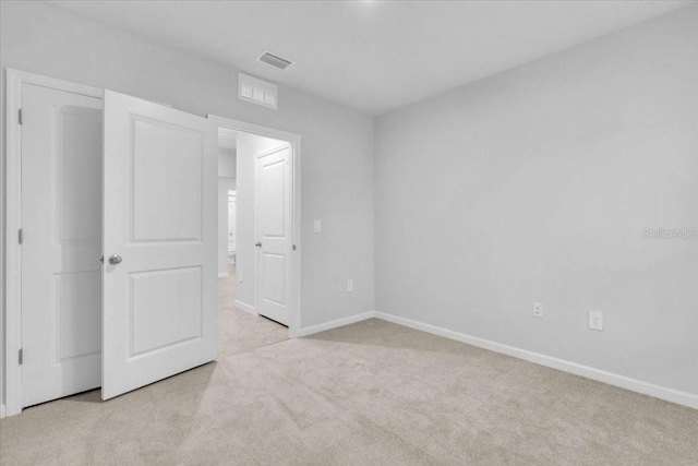 unfurnished bedroom featuring light colored carpet