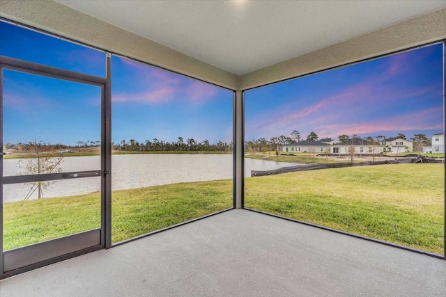 unfurnished sunroom with a water view