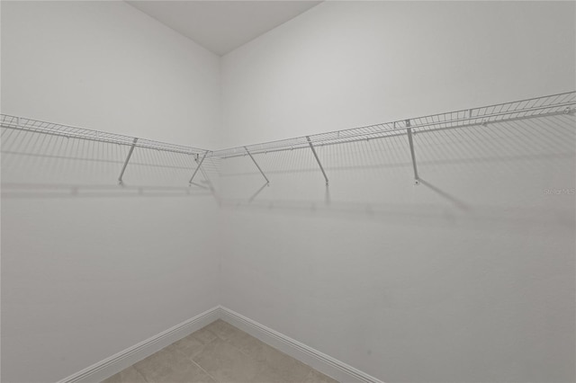 spacious closet featuring tile patterned floors