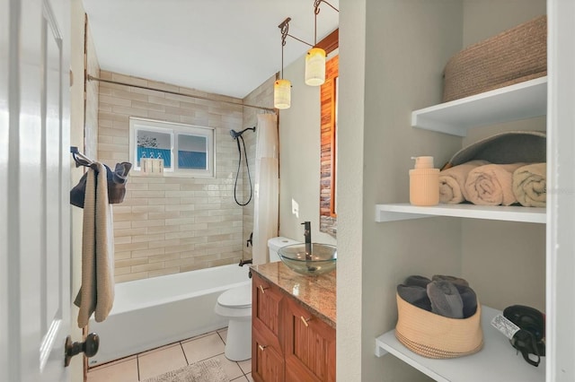 full bathroom featuring tile patterned floors, vanity, toilet, and tiled shower / bath combo