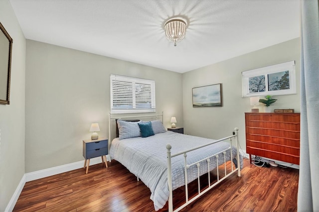 bedroom with dark hardwood / wood-style floors