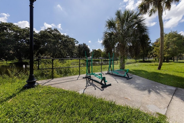 view of property's community featuring a lawn and a water view