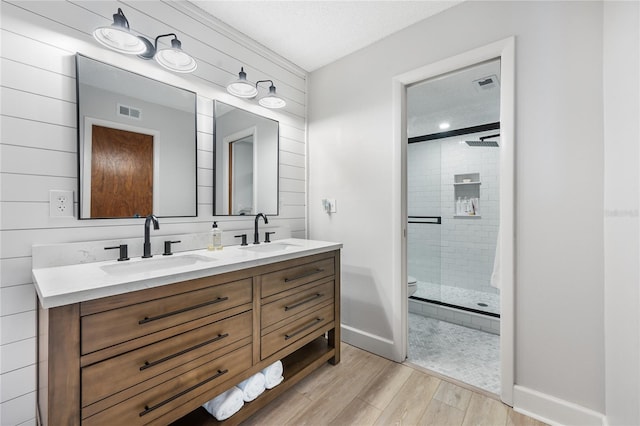 bathroom with vanity, an enclosed shower, and toilet