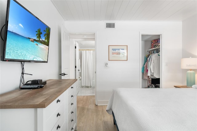 bedroom with wood ceiling, a closet, and light hardwood / wood-style floors