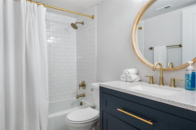 full bathroom with vanity, shower / bath combination with curtain, and toilet