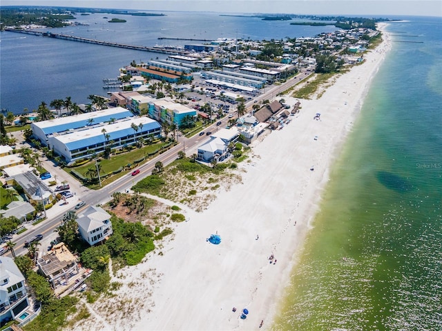 birds eye view of property featuring a water view and a beach view