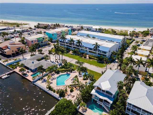 birds eye view of property featuring a water view and a beach view