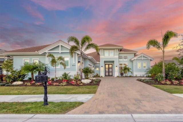 view of front of home featuring french doors and a yard