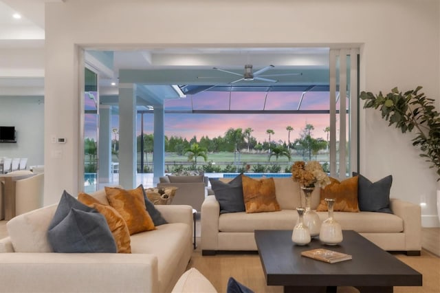 living room featuring light wood-type flooring and ceiling fan