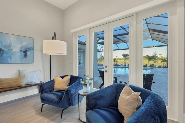 living area with hardwood / wood-style flooring and french doors