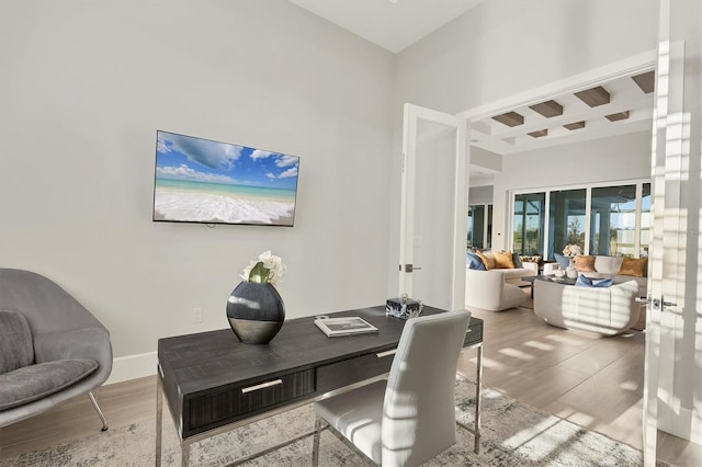 office space featuring french doors and hardwood / wood-style flooring