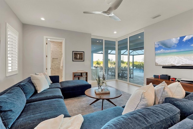 living room with wood-type flooring and ceiling fan