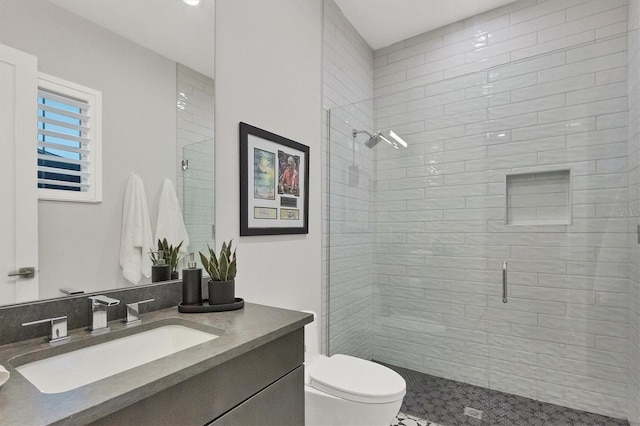 bathroom with vanity, toilet, and an enclosed shower