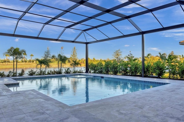 view of pool with a patio, a water view, and a lanai