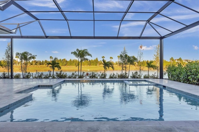 view of swimming pool with a patio, a water view, and glass enclosure