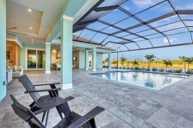 view of swimming pool with a lanai and a patio