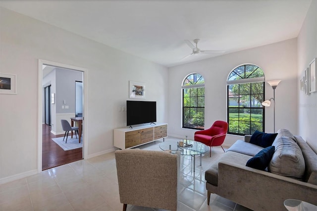 tiled living room featuring ceiling fan