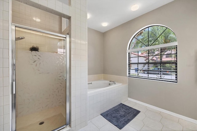 bathroom featuring tile patterned flooring and shower with separate bathtub