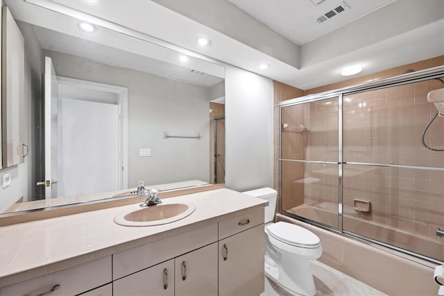 full bathroom with shower / bath combination with glass door, vanity, and toilet