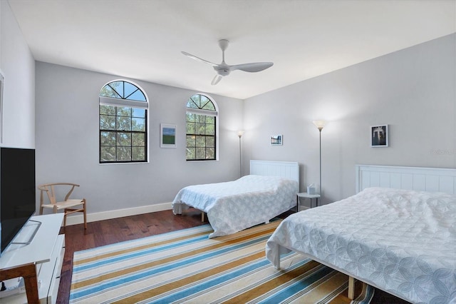 bedroom with ceiling fan and dark hardwood / wood-style flooring