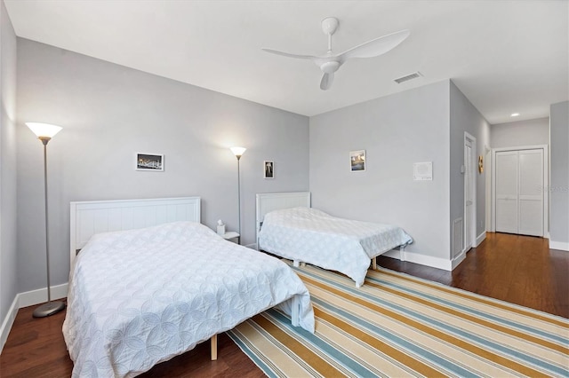 bedroom with ceiling fan and dark hardwood / wood-style floors