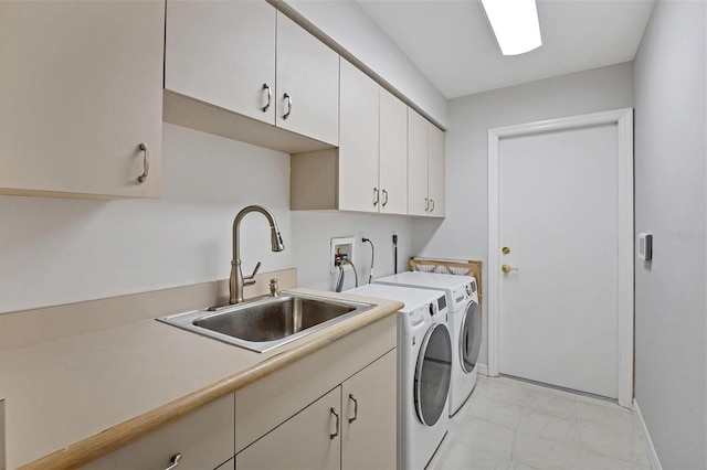 clothes washing area featuring cabinets, separate washer and dryer, and sink