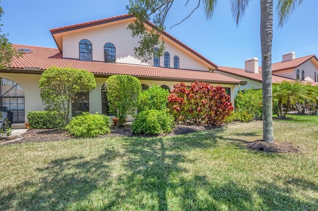 mediterranean / spanish house featuring a front lawn