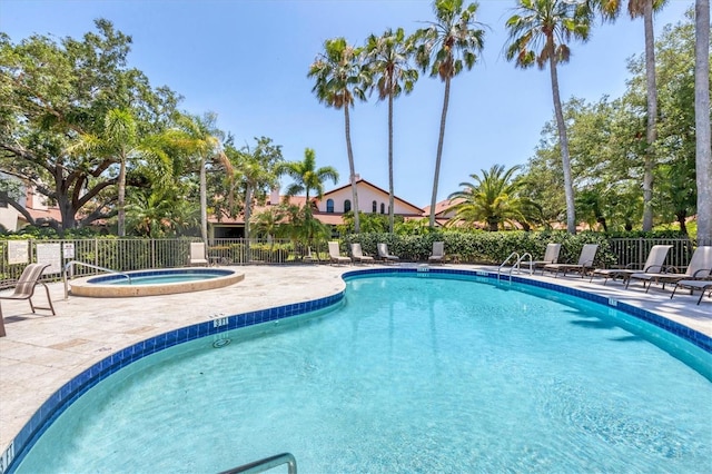 view of swimming pool with a community hot tub and a patio