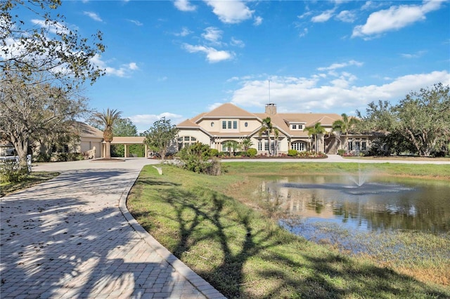 view of front of house with a water view