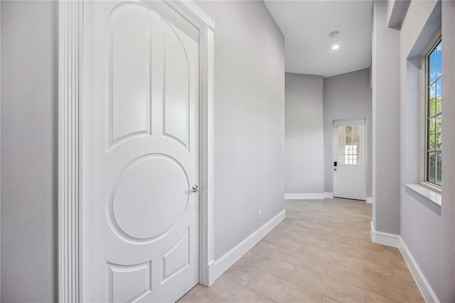 corridor featuring light tile patterned floors