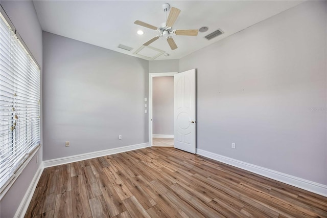 empty room with ceiling fan and light hardwood / wood-style floors