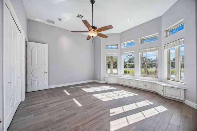 unfurnished bedroom with ceiling fan and light wood-type flooring