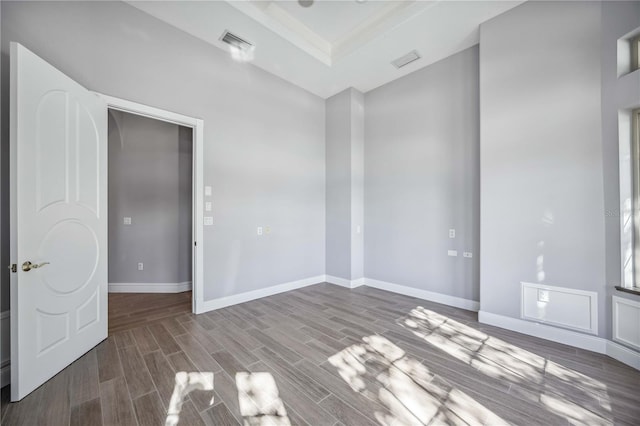 unfurnished room with a tray ceiling and crown molding