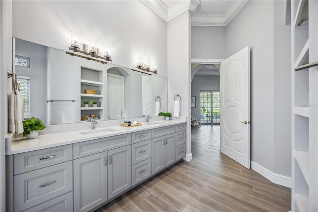 bathroom featuring hardwood / wood-style flooring, vanity, and crown molding