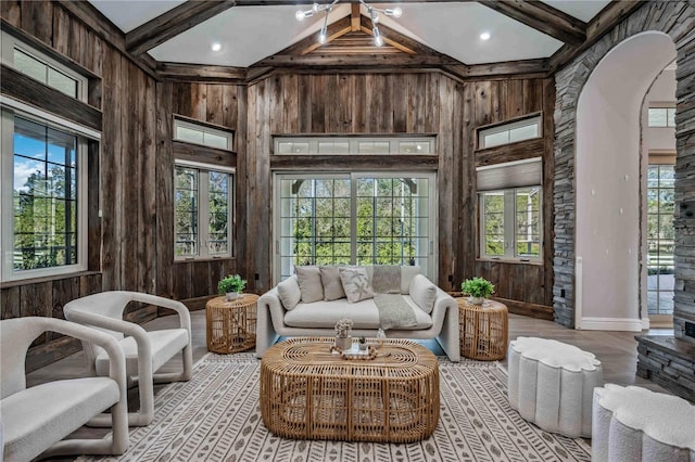 sunroom featuring beam ceiling