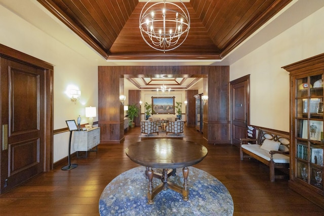 hallway featuring dark hardwood / wood-style floors, a chandelier, wood ceiling, a raised ceiling, and crown molding