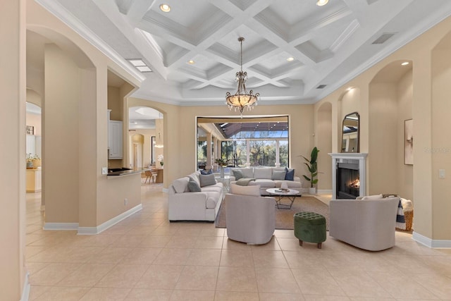 tiled living room featuring coffered ceiling, ornamental molding, a towering ceiling, and beam ceiling